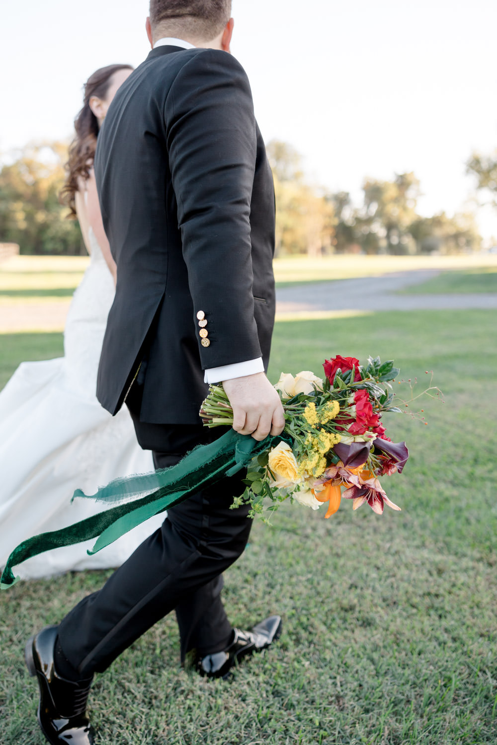 Washington DC bride and groom walking on their wedding day with a colorful bouquet - wedding planned by Bellwether Events Washington DC bride and groom walking on their wedding day with a colorful bouquet - wedding planned by Bellwether Events